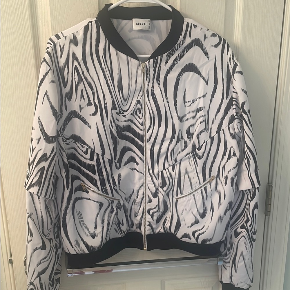 Suboo track type jacket. Convertible sleeves that zip off.